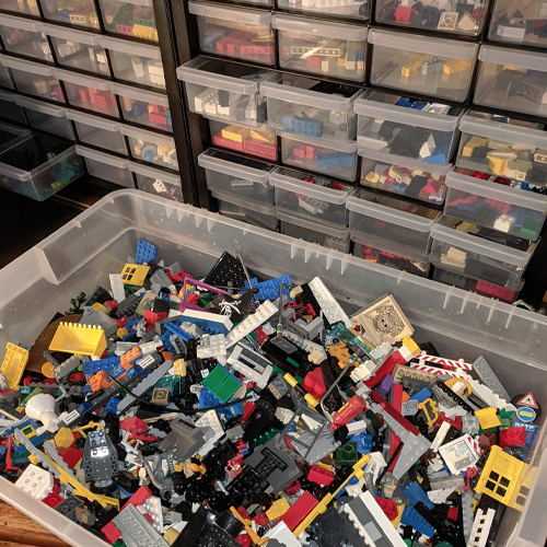 A bin and storage system filled with Lego bricks.